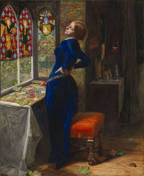 Painting. A pale-skinned woman, Mariana, wears a sapphire-blue, velvet gown as she stands and stretches, hands pressed into her lower back. Her embroidery is spread out on a table between her and the stained-glass window she faces. The wall next to her is covered with gold birds and plants against an aqua-blue background.
