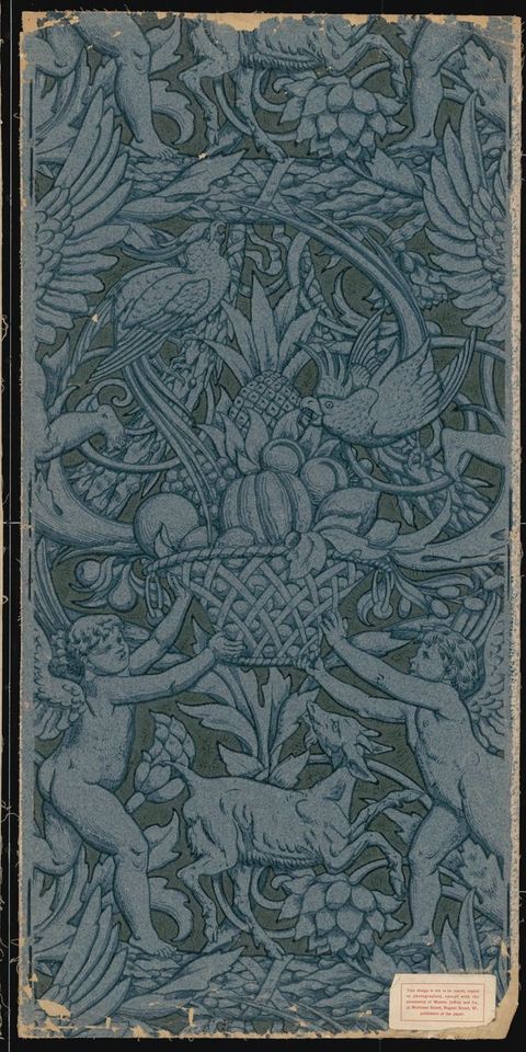 Print. Two winged, child-like putti hold up a basket piled high with fruit. Two parrots peck at the fruit, and a goat between the putti looks up at the basket. Stylized flowers and vines fill in most of the rest of the area. Here the pattern is printed so outlines and shading is blue on blue paper, and the background is a darker, muted blue.