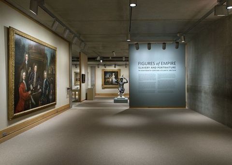 Installation photograph. This view of an exhibition includes the introductory wall panel. At the top, the largest letters read, 'Figures of Empire'. In letters about half as high, the subtitle below reads, 'Slavery and Portraiture', and in smaller text, 'in eighteenth-century Atlantic Britain'.