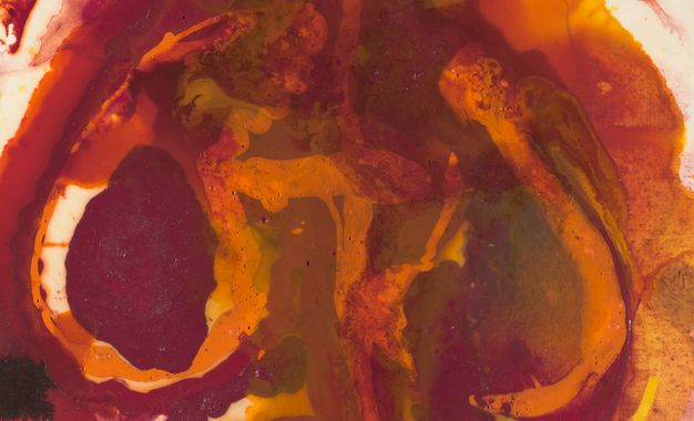 Detail shows distinct layers of red and orange pooling over another.
