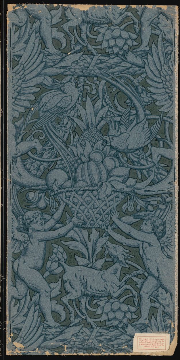 Print. Two winged, child-like putti hold up a basket piled high with fruit. Two parrots peck at the fruit, and a goat between the putti looks up at the basket. Stylized flowers and vines fill in most of the rest of the area. Here the pattern is printed so outlines and shading is blue on blue paper, and the background is a darker, muted blue.