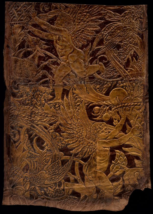 Embossed and painted leather. In low relief painted gold, two winged, child-like putti almost disappear among animals, birds, fruit, and flowers. The dark background contrasts with the embossed areas.