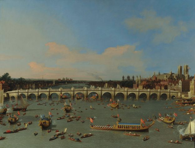 Painting. A grey stone bridge with fifteen arches crosses a river in this sunny landscape. The muted blue river is bustling with rowboats, ceremonial barges, and sailboats. Buildings lining the banks of the river meet in the deep distance at the horizon, which comes just under halfway up the composition.