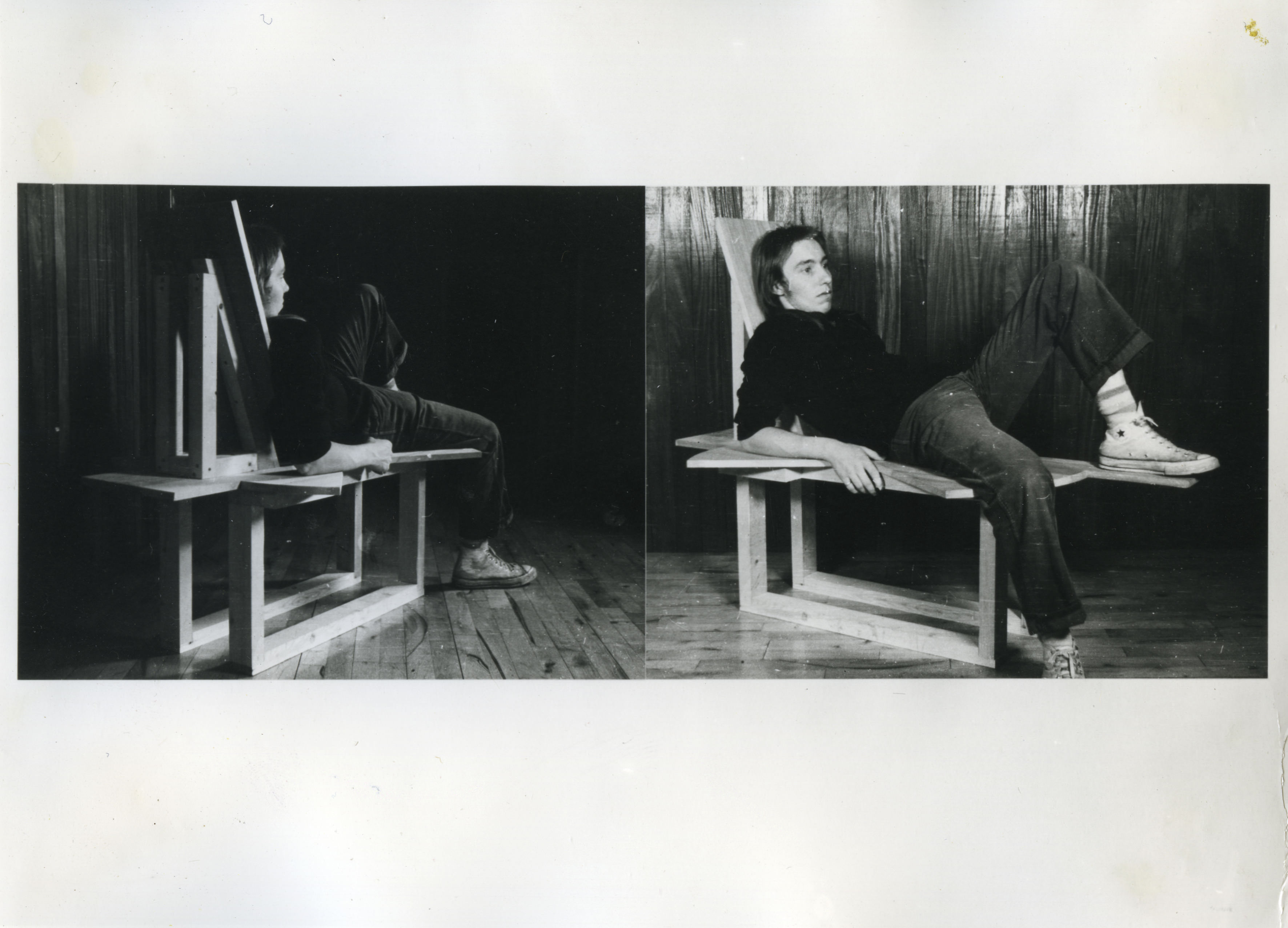 Two black and white photographs. Each photograph shows a pale-skinned man lying back on a wooden sculpture resembling a deconstructed chair. A projecting plank of wood gives him a place to prop up his foot. In one photograph, we look on from behind the man, and in the other, we see his face and body in profile.