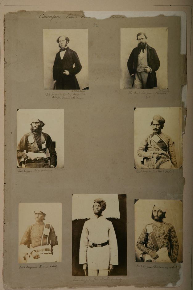 Page of a book. Each of seven black and white photographed portraits shows a man from about the thighs up. The two men at the top of the page have pale skin. The other five have darker skin and wear turbans.