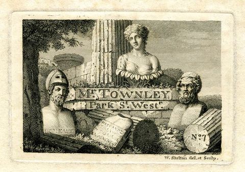 Print. Black lines on cream paper show three classical busts arranged at the base of a ruined column overgrown with vegetaion. Fragments of the column, and a tablet with an illegible inscription, surround them. On the base of the column, text reads “Mr. Townley Park St. West”.