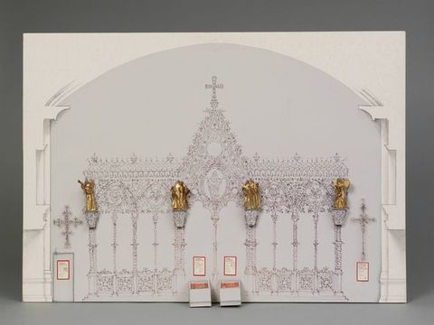 Model. The structure and filigree of a choir screen is drawn with ink on the model for an exhibit. Four sculptural groups are in gold at the top of the columns. Display cases with explanatory text are below.