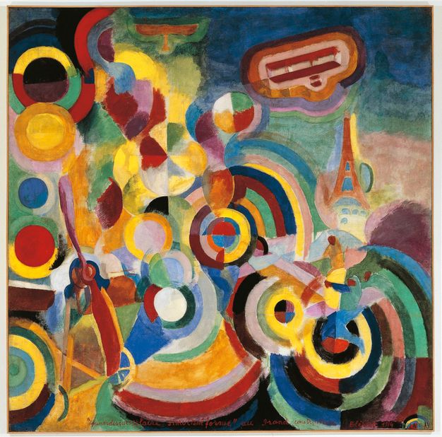 Painting. Amid a screen of nested, concentric circles, the propellor of a plane slowly emerges near the bottom left corner. Two planes are in a field of blue near the upper right. The Eiffel Tower appears under one of them. The painting is done mostly in tones of lemon yellow, burgundy and scarlet red, laurel and sage green, shades of blue, and black and white.