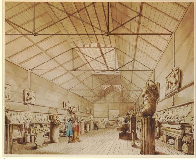 Watercolour. Sculptures and architectural fragments line the walls of this warehouse-like space with exposed rafters. The floor, ceiling, and walls appear to be wood. The scene is painted in amber-brown tones except for a man and woman who stand near the middle of the space. Their clothing has been painted turquoise and pink.