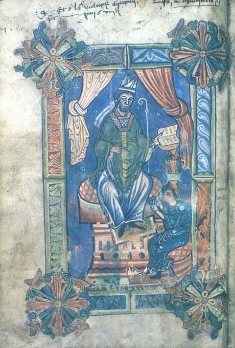 Illumination. A man wearing a split papal tiara and green and blue robes sits on a throne. He holds a book in one hand and points to a seated, tonsured monk at his feet.