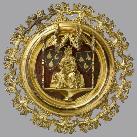 Plaque. A golden, medallion-like roundel shows an enthroned, crowned woman with a baby, the Virgin and Child, with heraldic shields to each side. The perimeter is made up of a band of angels, shown hand-in-hand from the waist up.