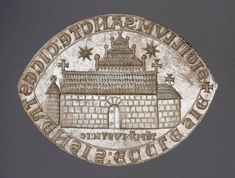 Seal. This oval seal has pointed ends, like a marquise-cut diamond. It shows a church with an attached chancel to our right and a freestanding tower to our left. A three-stepped tower structure is above the long roof of the church. Two starburst-like forms are in the sky. Words run around the perimeter of the seal.