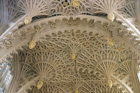 Architecture. The vaulted ceiling of a church chapel is carved into fanning, intricate, spirograph-like patterns that may, at first glance, look like handmade lace.