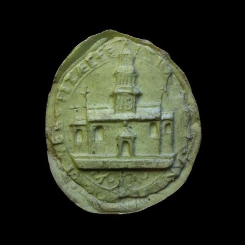 Seal. Cast in light green material, the circular seal shows a church with a tall tower over the central door. Text around the perimeter is difficult to make out.