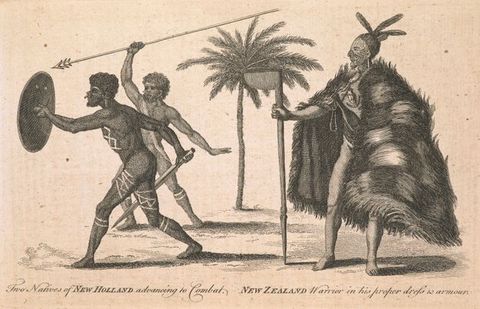 Print. Two nude men, their bodies marked with decorative lines and with bones through their noses and ears, advance to our left. One holds a round shield and a pointed stick, the other a spear. A man wearing a voluminous fur cape and with feathers in his hair stands to our right. Text below reads, \“Two Natives of New Holland advancing to Combat. New Zealand Warrior in his proper dress & armour\”.
