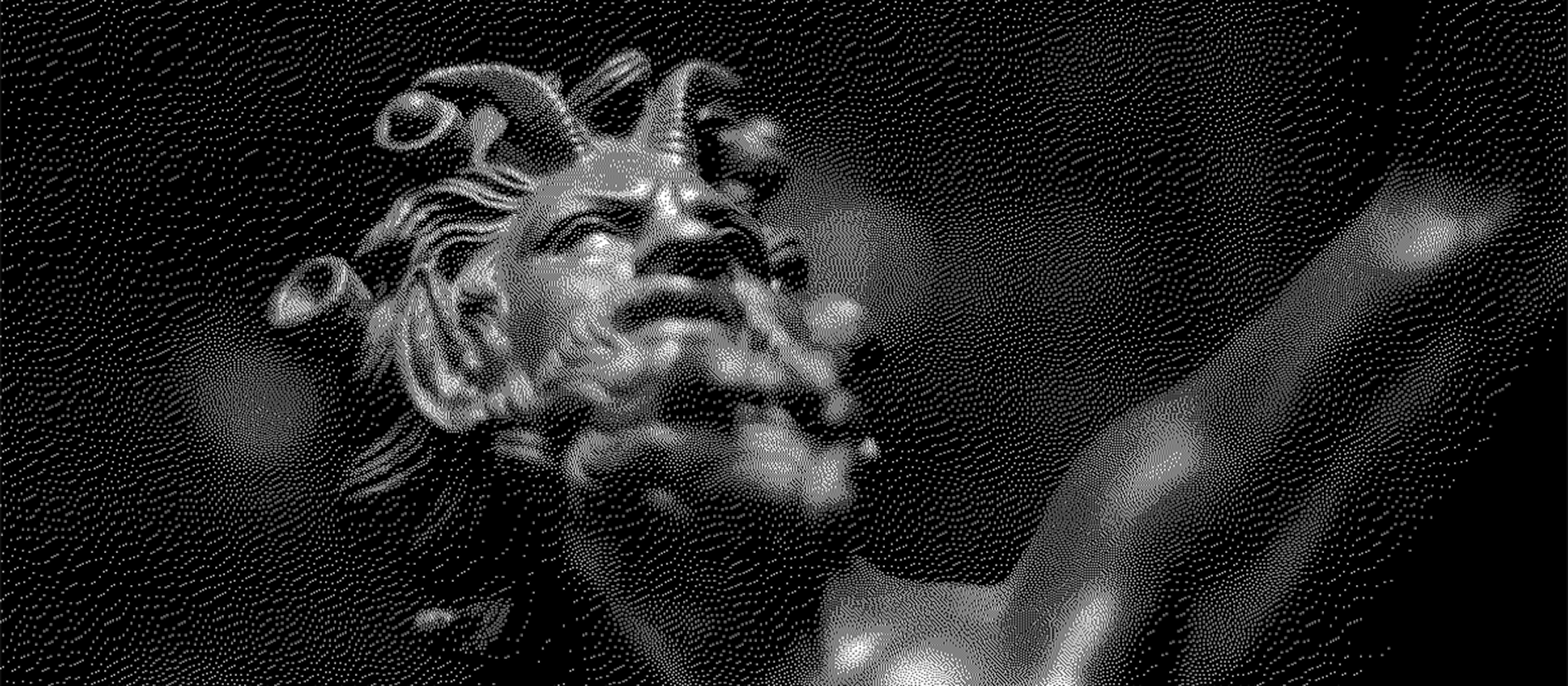 Sculpture. A close-up of a bronze statue depicting a bearded male figure with an intense expression. His hair is adorned with curled horns or stylized locks, giving him a mythical or divine appearance. The lighting casts dramatic shadows on his face, emphasizing the texture of the sculpture. The background is blurred with soft, glowing lights, creating a sense of depth and atmosphere.