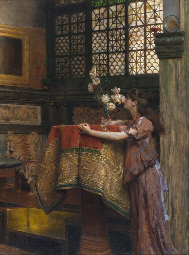 Painting. A woman stands and smells a spray of white roses placed on a high table or platform near the corner of a room. Leaded glass windows in fish-scale or triangular-patterned panes line the upper half of the wall to our right. We catch glimpses of a stone wall, capital, a gold frame, a tiger’s pelt, and a built-in platform partially lined with shiny gold.
