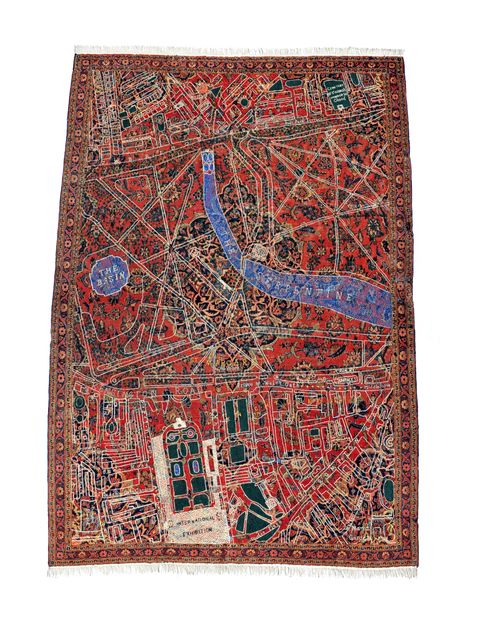 Textile. A map of Hyde Park is embroidered over a carpet patterned with red, black, peach, and green in floral designs. The map is mostly white for the streets, walkways, and buildings, and blue for areas labelled “The Basin” and “The Serpentine”.