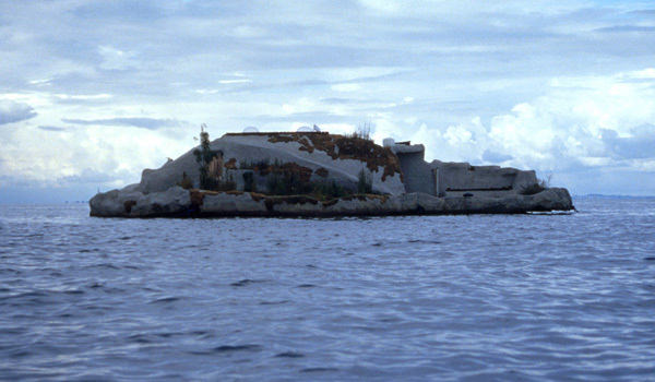 A concrete island floats across an expanse of water.