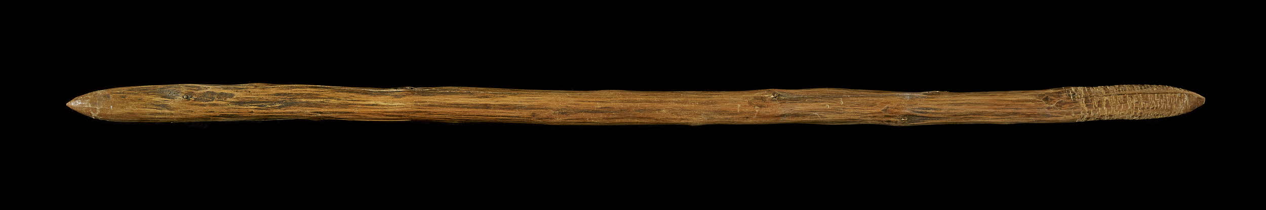 Thin wood club with pointed ends.