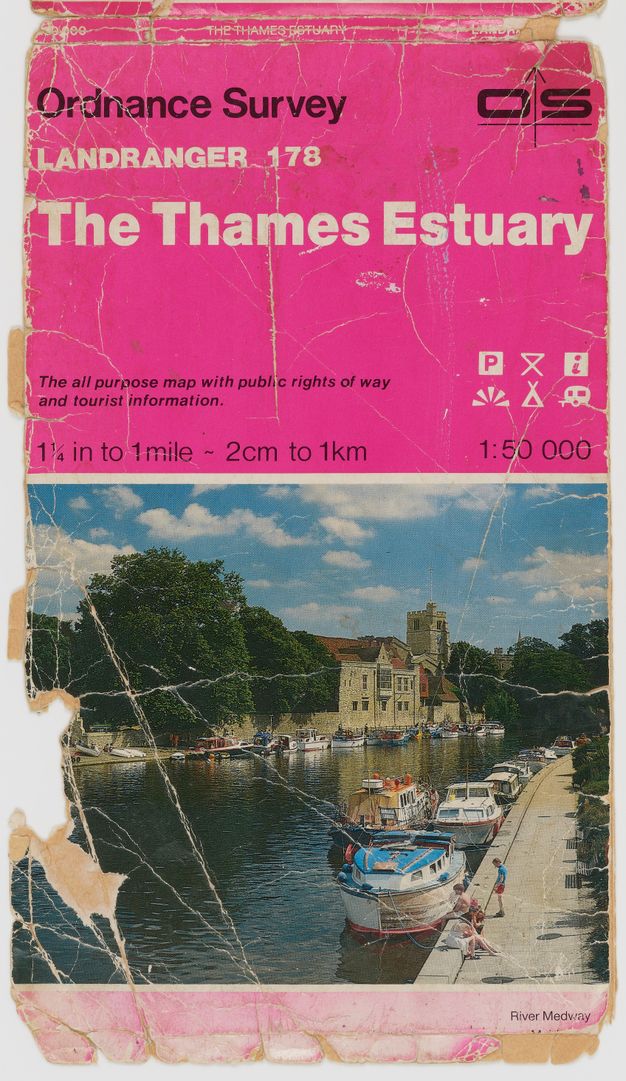 Map cover. The top of half has black and white text against a fuchsia-pink background. A colour photograph of a boat-lined river is below.