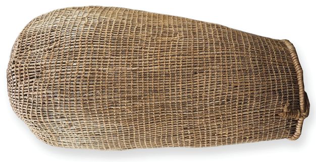 Basket. Long woven vessel has a rounded bottom and a slightly tapering neck.