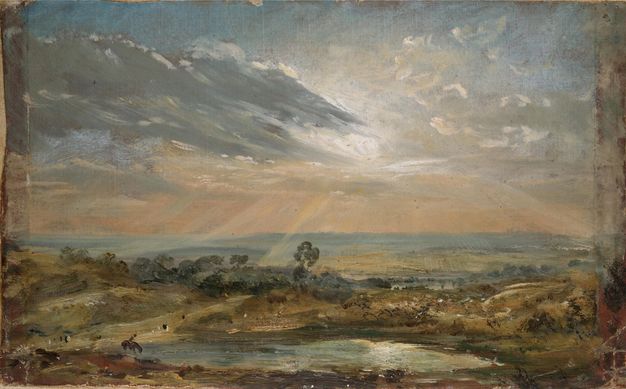 Painting. A pond lies low across the bottom edge of this loose oil sketch. The landscape around it is painted with tawny brown and shades of blue. Rays of sun burst from behind a bank of clouds.