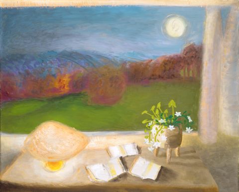 Painting. The light of a low lamp warms the surface of a table or desk in front of an open window. The twilight or nighttime landscape beyond has a band of raspberry-pink and bronze-brown trees and shrubs across a grassy field. Loosely painted indigo-blue mountains line the horizon under a periwinkle-blue sky. A sorbet-yellow moon hangs low in the sky to our right.