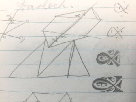 Drawing. Geometric shapes and looping forms are doodled on lined paper.