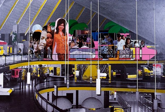 Collage. The topmost of three levels around an open space lined with balconies is filled with collaged photographs of people, some reaching high into the angled ceiling above.