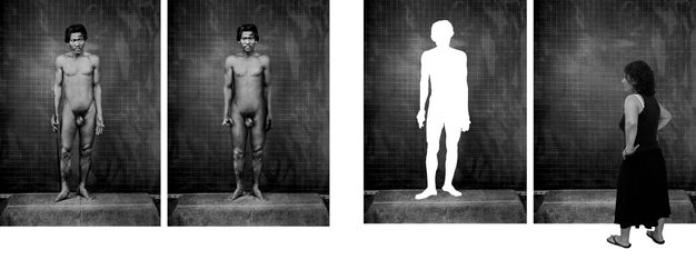 Black and white photographs. Four images are arranged in two pairs. The left two show nude, dark-skinned men standing facing the camera, arms by their sides, against a studio backdrop. In the pair to our right, the man’s body has been cut out so only a bright white silhouette remains. A woman stands in front of the other image, which has no person in front of the backdrop.
