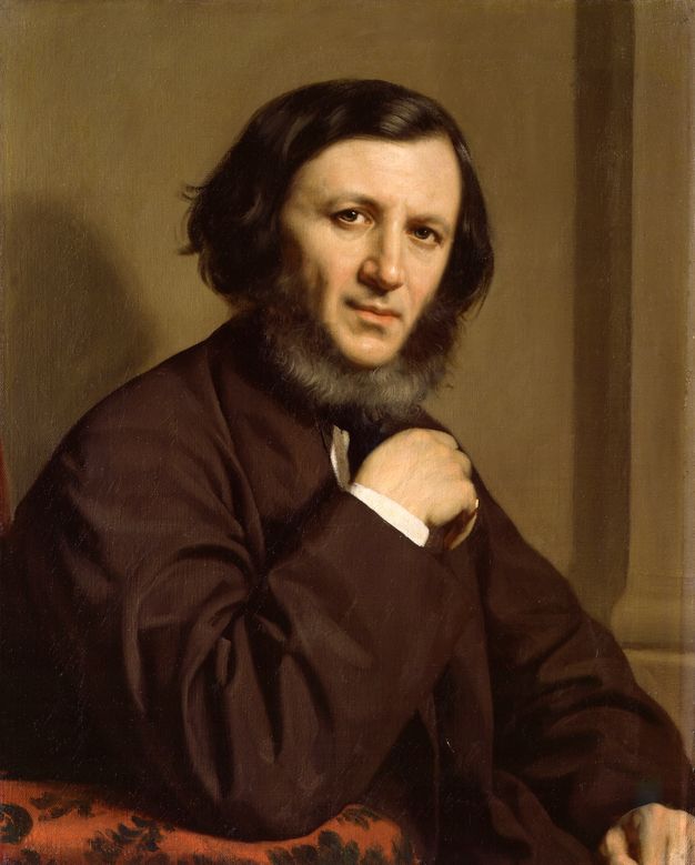 Painting. Shown from the waist up, a pale-skinned man sits with one elbow propped on the table in front of him, that hand limp, as he looks at us with brown eyes. His chin-length brown hair is parted to our right side and combed over the top of his head to meet a beard that grows only on the underside of his chin.