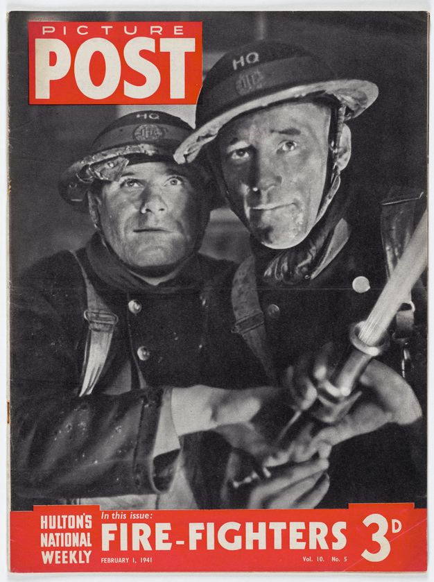 Magazine cover. A black and white photograph of two men, wearing uniforms and their pale skin dirtied, aiming a fire hose out of frame to our right, as they look up. Their eyebrows are knit and their lips set. The magazine’s name is in white text in a red box at the top left. In a red banner below, white text reads “Houlton’s National Weekly In this issue: Fire-Fighters February 1, 1941 Vol. 10 No. 5 3D”.