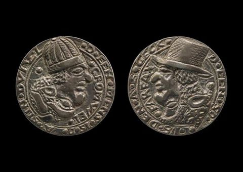 Medal. Both sides show profile portraits of men, both with exaggerated, bulbous features. The man on the recto, to our left, wears a rounded cap. The other, to our right, a brimmed hat. Text is around the perimeter of each.