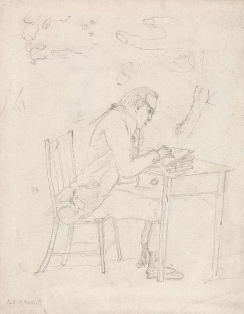 Drawing. A man leans forwards in a wooden chair as he sketches at a small table. The tails of his coat bunch on the seat of the chair, and he looks down through glasses.