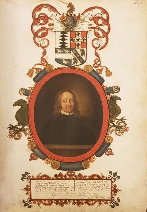 Painting. A pale-skinned man wearing black is shown from the waist up behind a ledge within an oval frame. His brown hair hangs to his shoulders, and he has a moustache over the hint of a double chin. The frame is painted with scrolls and eagles under a heraldic shield. Handwritten text appears in a cartouche below.