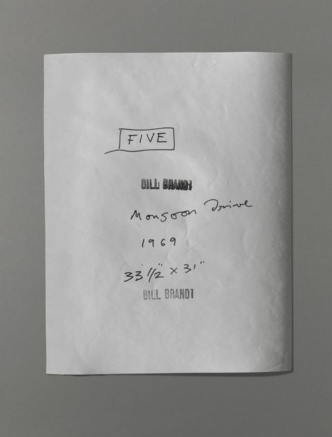 The back of a photograph has the title, date, and dimensions written in black pen. A stamp reading “Bill Brandt” was pressed twice, though one is blurry with too much ink.