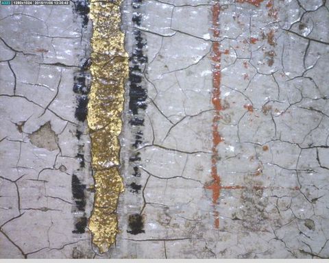 Painting. Detail view of a cracked painted surface with gold, black, or dark red bands against white.