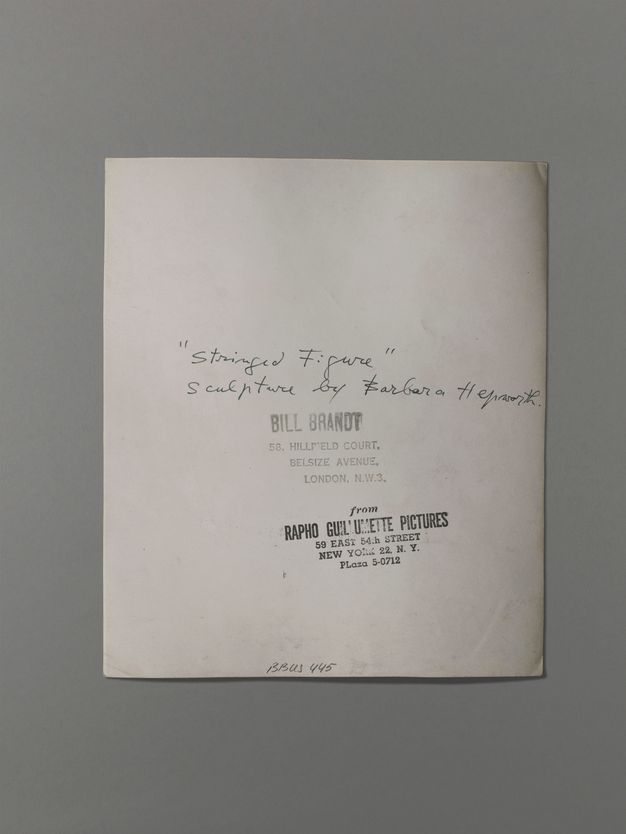 The back of a photograph has the title written in pen and two stamps. One stamp reads “Bill Brandt 58, Hillfield Court. Belsize Avenue. London. N.W.3” and the other, “from Rapho Guillemette Pictures 59 East 54th Street New York 22, N.Y. PLaza 5-0712”.