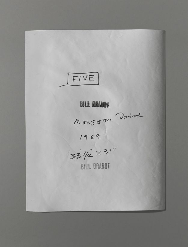 The back of a photograph has the title, date, and dimensions written in black pen. A stamp reading “Bill Brandt” was pressed twice, though one is blurry with too much ink.