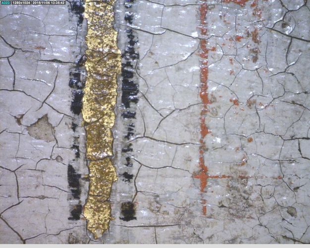 Painting. Detail view of a cracked painted surface with gold, black, or dark red bands against white.