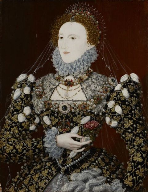 Painting. Shown from the hips up, a smooth-skinned woman with a nearly ash-white face and red curly hair is shown against a port-wine-red background. She is angled to our left and looks in that direction with brown eyes. Her crown, jewellery, and dress are encrusted with gold, gems, and pearls.