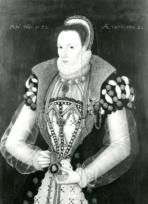 Painting. Black and white reproduction of a woman shown from the hips up, holding open a portrait medallion by her waist. She wears a headdress, ruff around her neck and jewels hang from her necklace and possibly her clothing.