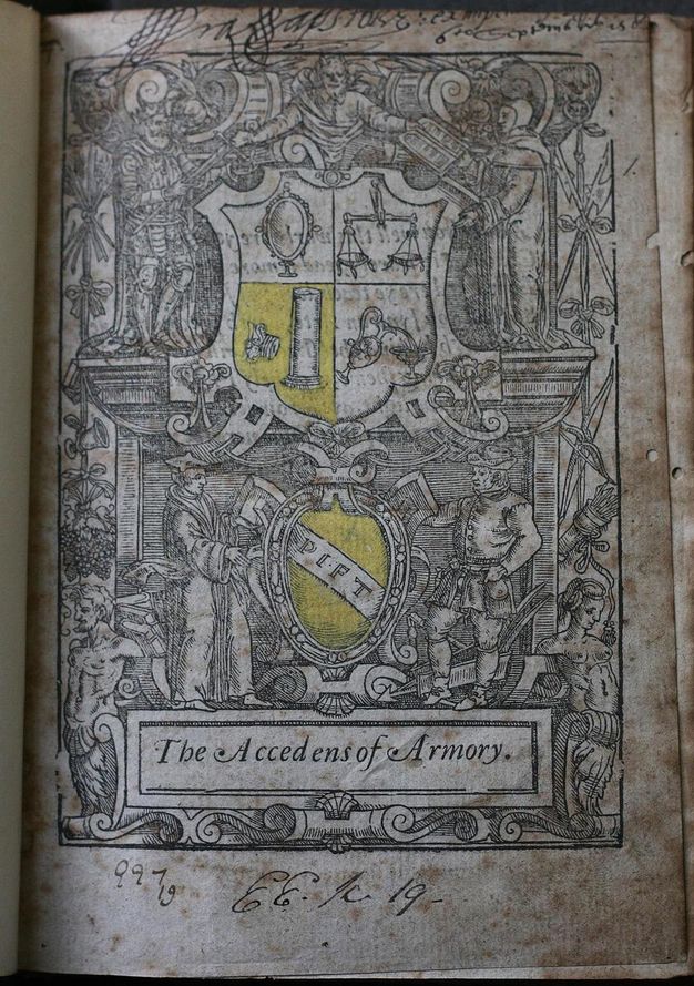 Title page. A coat of arms and shield are surrounded five people within an intricate design of ornamental strapwork, scrolls, and still life elements including foodstuff and weapons. Handwritten inscriptions are above and below the illustration.