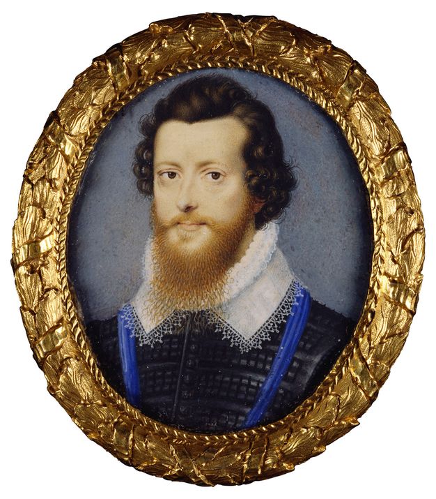 Watercolour. A pale-skinned man is shown from the chest up against a slate-blue background in this oval portrait. His chestnut-brown curls are brushed back from his hairline, and his ginger-red beard overlaps the pleated ruff and the lacy collar he wears. He has dark eyes and delicate pink lips.