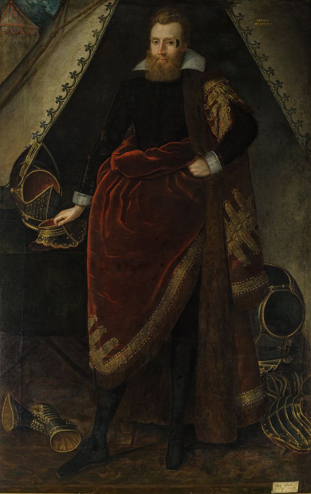 Painting. Full-length portrait of a pale-skinned, blond man standing at the entrance to a military tent. A dark, crescent-shape is on his face next to one eye, and he has a full, squared off beard. One hand rests on a piece of armour on a table next to him, and more of the armour is on the ground around his feet.