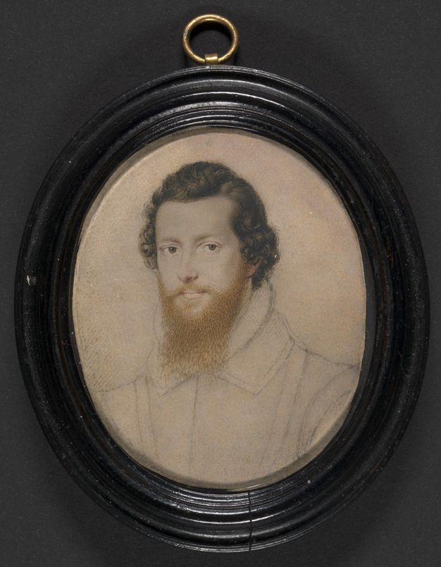Watercolour. The pale face, chestnut-brown hair, and ginger beard of a man are painted in detail. His costume is sketched in. The oval portrait is in a wood frame.
