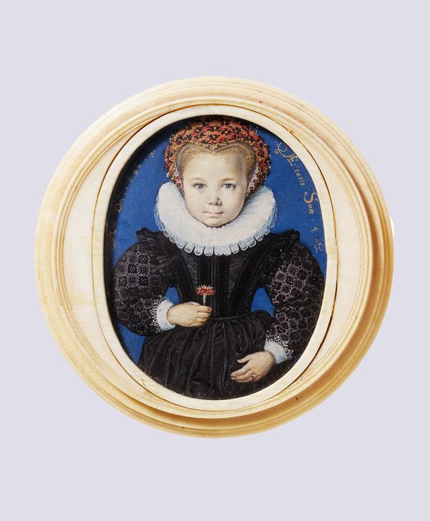 Watercolour. Set in a carved ivory frame, a young, smooth-cheeked, pale-skinned girl looks squarely out at us with blue eyes. Her blond hair is mostly covered in a red, black, and gold headdress, and she wears a wide, white pleated ruff and a black dress. She holds a carnation in front of her bodice.