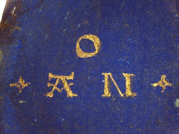 Watercolour. Detail view of three letters, O, A, and N, in gold against ultramarine blue.