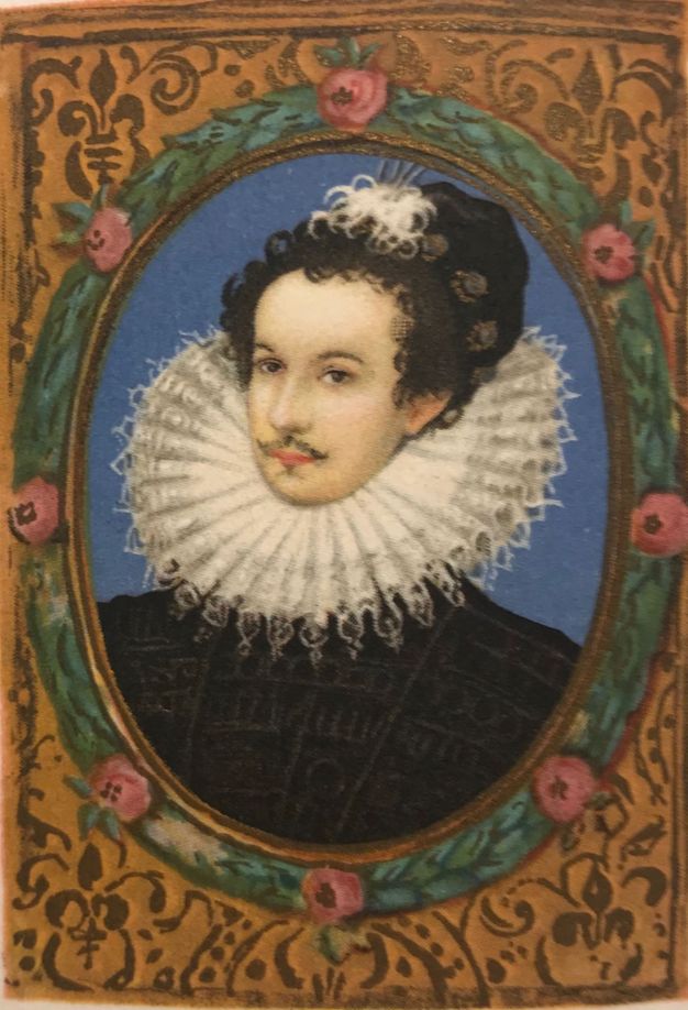 Print. A pale-skinned man in an oval frame has a delicate goatee, and he wears a white-feathered cap set back on dark curls. A wide, pleated lace ruff fans out under his chin and angles up the back of his head. He wears a black doublet. The print is hand-coloured with an azure-blue background, and the frame is painted green with pink flowers.